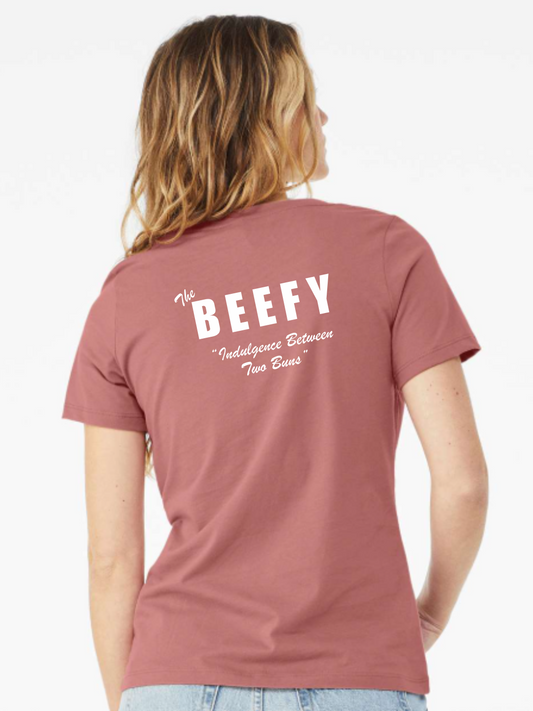 Person wearing a pink t-shirt with 'BEEFY' text on the back, on a white background