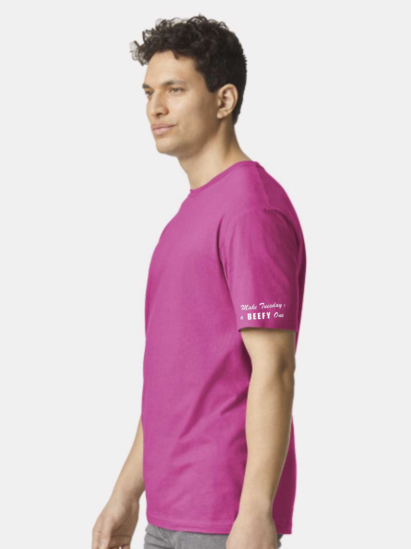 Man wearing a pink t-shirt with text on a white background